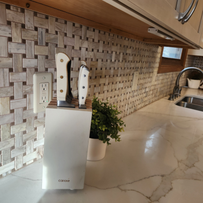 Custom tile backsplash in a kitchen with marble countertops